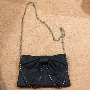 Black leather bag with bow and studs